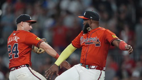 Atlanta Braves designated hitter Marcell Ozuna, right, and outfielder Jarred Kelenic (24) celebrate after defeating Toronto Blue Jays in a baseball game Friday, Sept. 6, 2024, in Atlanta. (AP Photo/John Bazemore)