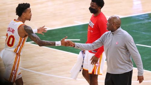 062321 Milwaukee: Atlanta Hawks forward John Collins gets five from interim head coach Nate McMillan after his three pointer against the Milwaukee Bucks in game 1 of the NBA Eastern Conference Finals at Fiserv Forum on Wednesday, June 23, 2021, in Milwaukee.   “Curtis Compton / Curtis.Compton@ajc.com”