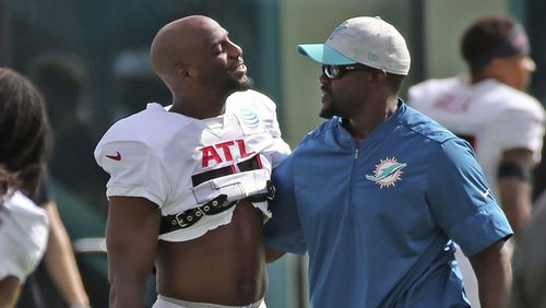 Falcons cornerback Duron Harmon (left) and Dolphins coach Brian Flores greet one another during a joint training camp practice at the Dolphins training facility Wednesday, Aug. 18, 2021, in Miami Gardens, Fla.  (Charles Trainor Jr./Miami Herald)