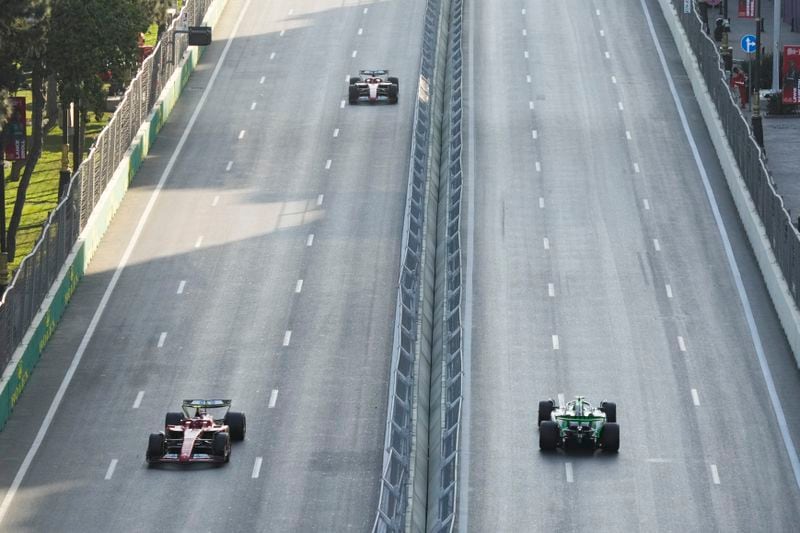 Ferrari driver Carlos Sainz of Spain, left front, drives in front of his teammate Charles Leclerc of Monaco during a Formula One Grand Prix practice in Baku, Azerbaijan, on Friday, Sept. 13, 2024. (AP Photo/Sergei Grits)