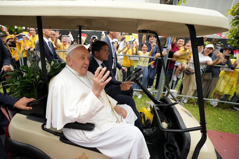 Pope Francis greets the volunteers on his arrival in Singapore, Wednesday, Sept. 11, 2024. (AP Photo/Vincent Thian)