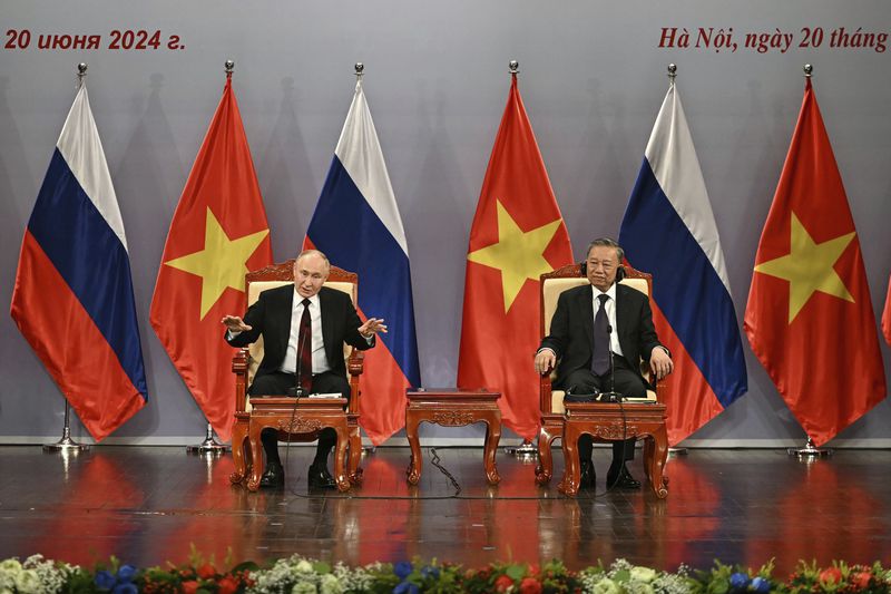 Russia's President Vladimir Putin, left, and Vietnam's President To Lam attend an event attended by the Vietnam Friendship Association and generations of Vietnamese alumni that studied in Russia at the Hanoi Opera House in Hanoi, Thursday June 20, 2024. (Manan Vatsyayana, Pool Photo via AP)
