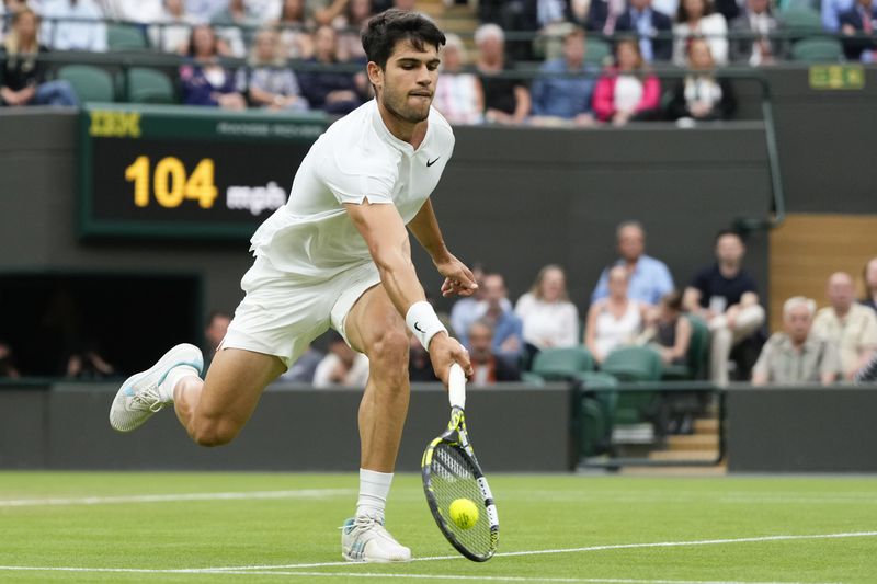 Carlos Alcaraz of Spain plays a forehand return to Tommy Paul of the United States during their quarterfinal match at the Wimbledon tennis championships in London, Tuesday, July 9, 2024. (AP Photo/Kirsty Wigglesworth)