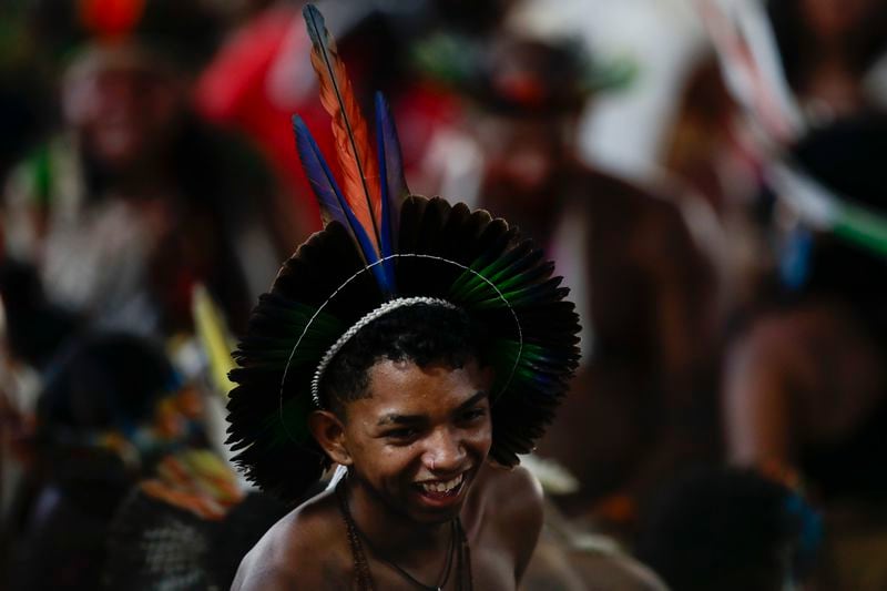 An Indigenous person smiles before a ceremony celebrating the return of the Indigenous Tupinamba people's sacred cloak to Brazil, in Rio de Janeiro, Thursday, Sept. 12, 2024. The garment, made from bird feathers and plant fibers, was repatriated to Brazil after having spent more than 300 years in the National Museum of Denmark. (AP Photo/Bruna Prado)