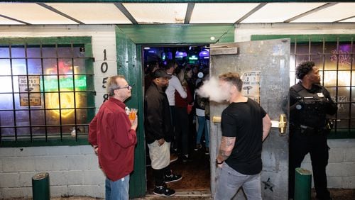 People hang out outside Northside Tavern in Atlanta on Saturday, November 26, 2022. This year the bar celebrates its 50th anniversary.(Arvin Temkar / arvin.temkar@ajc.com)