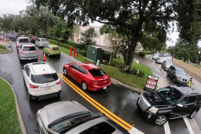 Cars wait in line to get into the parking lot for gas at Costco, Monday, Oct. 7, 2024, in Altamonte Springs, Fla., as residents prepare for the impact of approaching Hurricane Milton. (Joe Burbank/Orlando Sentinel via AP)