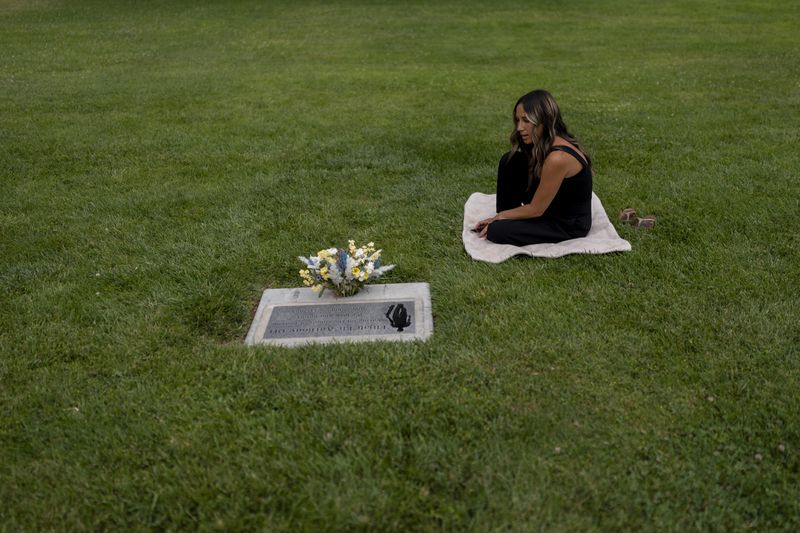 Mikayla Brown visits the grave of her son, Elijah, who died of a fentanyl overdose at 15, in Paso Robles, Calif., Friday, Aug. 2, 2024. (AP Photo/Jae C. Hong)