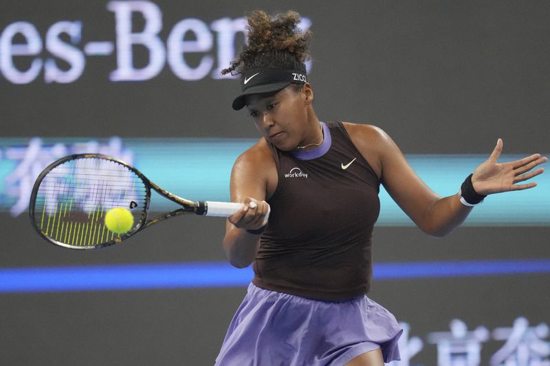 Naomi Osaka of Japan returns a shot to Coco Gauff of the United States in a women's singles match for the China Open tennis tournament held at the National Tennis Center in Beijing, Tuesday, Oct. 1, 2024.(AP Photo/Achmad Ibrahim)