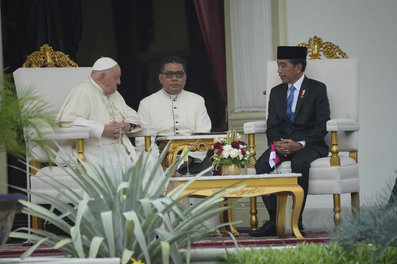 Pope Francis, left, talks with Indonesian President Joko Widodo, right, at the Presidential Palace in Jakarta, Indonesia, Wednesday, Sept. 4, 2024. (AP Photo/Achmad Ibrahim, Pool)