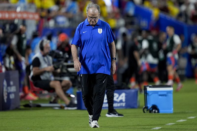 Uruguay's coach Marcelo Bielsa walks the sideline during a Copa America semifinal soccer match against Colombia in Charlotte, N.C., Wednesday, July 10, 2024. (AP Photo/Julia Nikhinson)