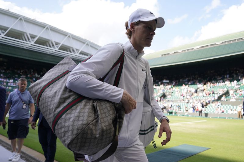 FILE - Italy's Jannik Sinner walks off court after defeating Colombia's Daniel Elahi Galan in the men's singles match on day seven of the Wimbledon tennis championships in London, July 9, 2023. (AP Photo/Alberto Pezzali, File)