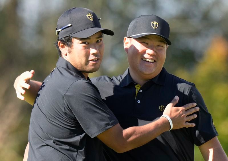 International team member Hideki Matsuyama, of Japan, left, celebrates with partner Sungjae Im, of South Korea, after a birdie on the 10th hole during the second round of the Presidents Cup golf tournament at Royal Montreal Golf Club in Montreal, Friday, Sept. 27, 2024. (Frank Gunn/The Canadian Press via AP)