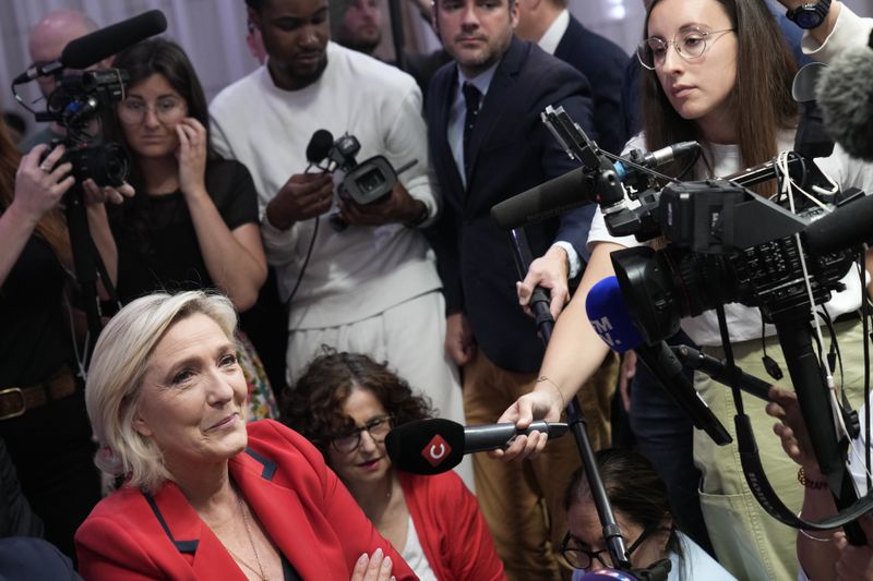 French far-right leader Marine Le Pen, left, attends a press conference by far-right National Rally party president Jordan Bardella, Monday, June 24, 2024 in Paris. The upcoming two-round parliamentary election will take place on June 30 and July 7. (AP Photo/Christophe Ena)