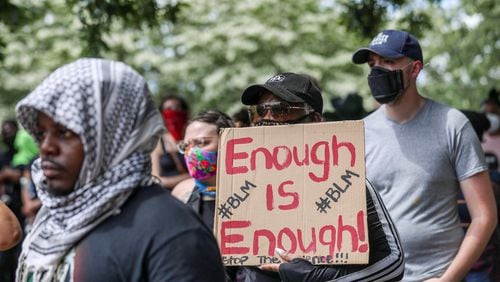 A Black Lives Matter supporter holds a sign during a rally at Atlanta’s Cleopas Park. Protests over the death of George Floyd in Minneapolis police custody continue around the United States, as his case renewed anger about incidents involving African Americans, police and race relations. Alyssa Pointer / alyssa.pointer@ajc.com