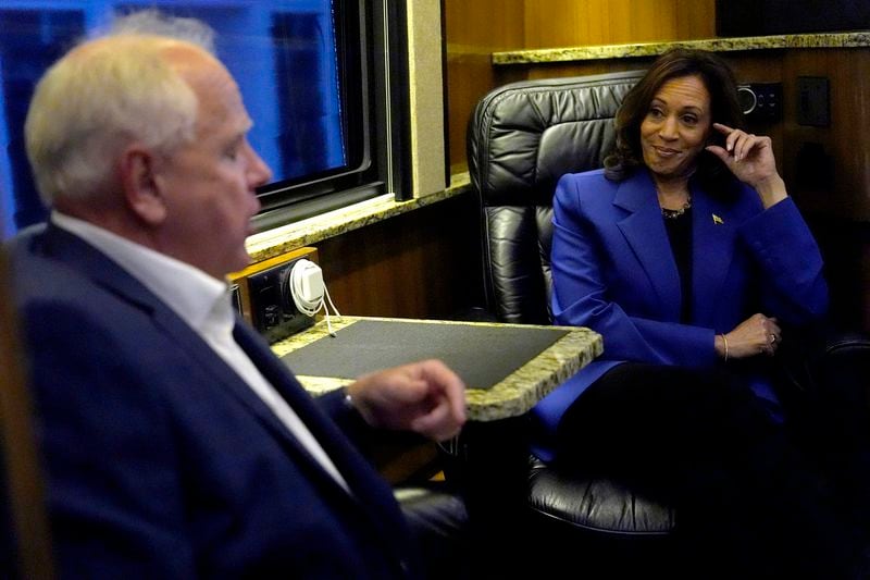 Democratic presidential nominee Vice President Kamala Harris, right, speaks with Democratic vice presidential nominee Minnesota Gov. Tim Walz on a bus during a campaign tour, Sunday, Aug. 18, 2024, in Rochester, Pa. (AP Photo/Julia Nikhinson)