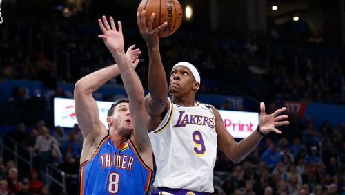 Los Angeles guard Rajon Rondo (9) goes to the basket past Oklahoma City forward Danilo Gallinari (8) Saturday, Jan. 11, 2020, in Oklahoma City. Both Rondo and Gallinari have signed on to play in Atlanta for the 2021 season. (Sue Ogrocki/AP)