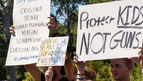 Students who walked out of their schools Friday hold up signs during a rally at J.B. Williams Park on Sept. 20, 2024. (Olivia Bowdoin for the AJC)