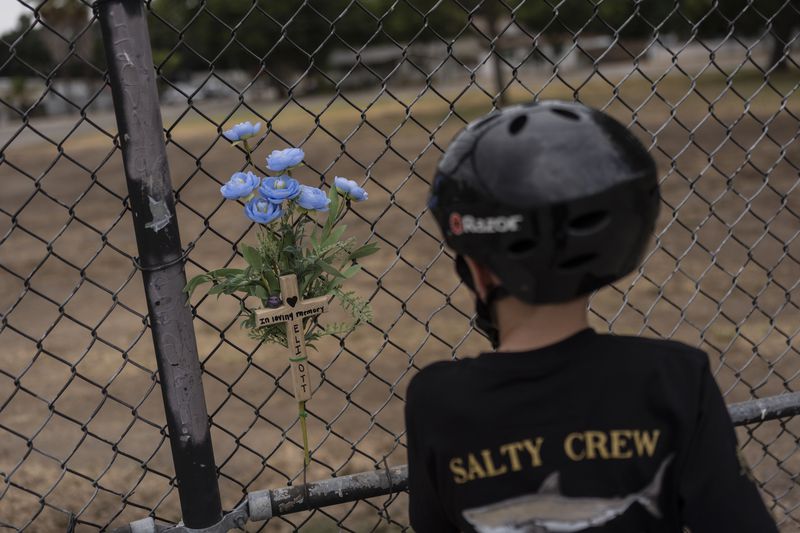 Jax Brown, half-brother of Elijah Ott, who died of a fentanyl overdose at 15, looks at a memorial for Elijah at a skateboard park in Paso Robles, Calif., Friday, Aug. 2, 2024. (AP Photo/Jae C. Hong)