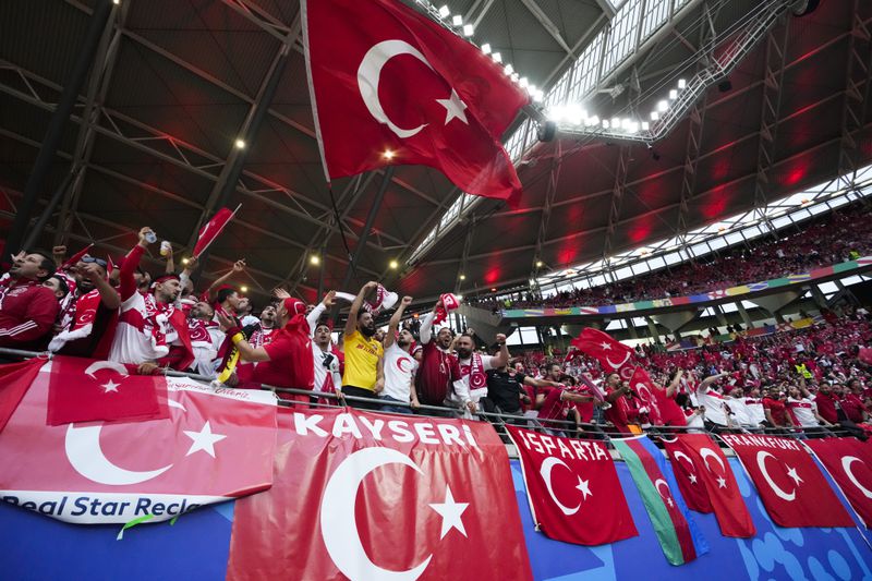 Turkey fans cheer before a round of sixteen match between Austria and Turkey at the Euro 2024 soccer tournament in Leipzig, Germany, Tuesday, July 2, 2024. (AP Photo/Martin Meissner)