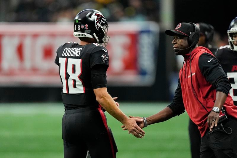 Atlanta Falcons head coach Raheem Morris greets Falcons quarterback Kirk Cousins during the first half of an NFL football game against the Pittsburgh Steelers on Sunday, Sept. 8, 2024, in Atlanta. (AP Photo/John Bazemore)