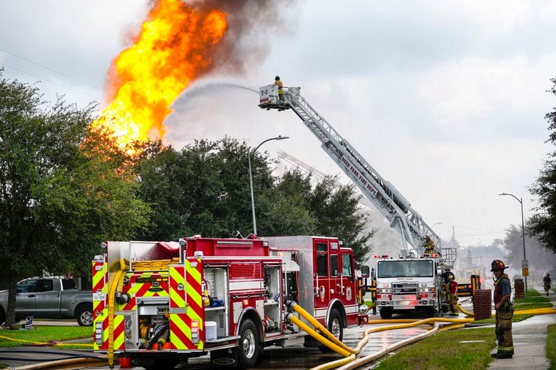 Firefighters protect a neighborhood from a fire in a pipeline carrying liquified natural gas burns near Spencer Highway and Summerton on Monday, Sept. 16, 2024, in La Porte, Texas. (Brett Coomer/Houston Chronicle via AP)