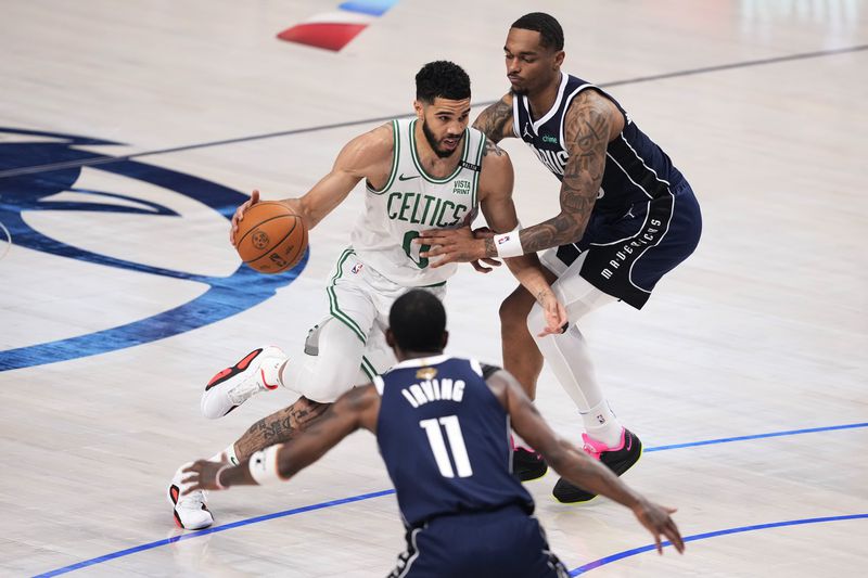 Boston Celtics forward Jayson Tatum (0) drives against Dallas Mavericks forward P.J. Washington, right, during the first half in Game 4 of the NBA basketball finals, Friday, June 14, 2024, in Dallas. (AP Photo/Sam Hodde)