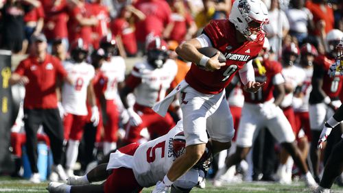 Jacksonville State edge Reginald Hughes (5) attempts to bring down Louisville quarterback Tyler Shough (9) during the second half of an NCAA college football game in Louisville, Ky., Saturday, Sept. 7, 2024. (AP Photo/Timothy D. Easley)