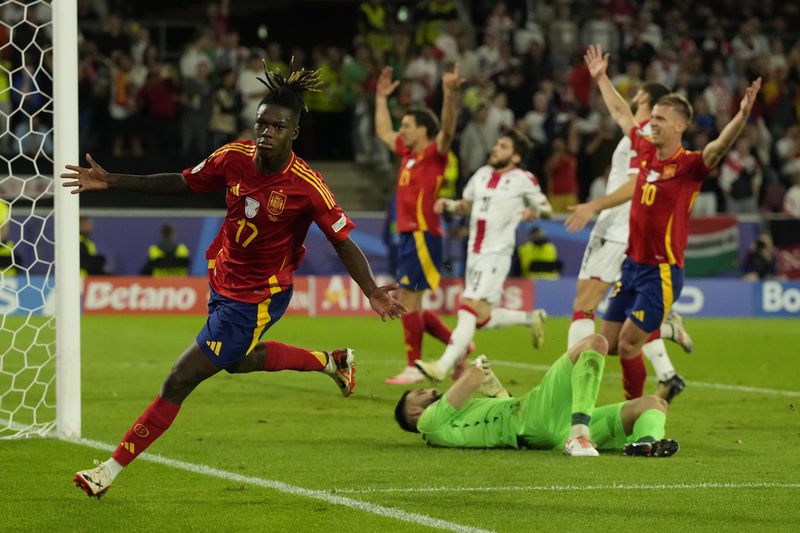 Spain's Nico Williams celebrates after scoring his side's 3rd goal against Georgia during a round of sixteen match at the Euro 2024 soccer tournament in Cologne, Germany, Sunday, June 30, 2024. (AP Photo/Frank Augstein)