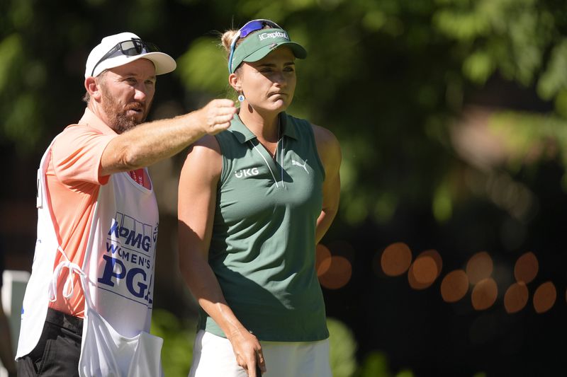 Lexi Thompson talks with her caddie on the 12th tee during the first round of the Women's PGA Championship golf tournament at Sahalee Country Club, Thursday, June 20, 2024, in Sammamish, Wash. (AP Photo/Gerald Herbert)