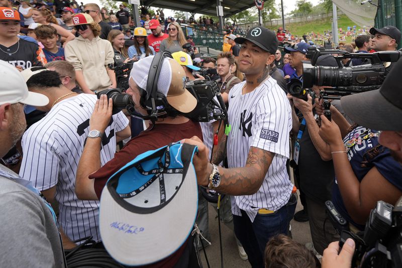 New York Yankees' Luis Gil, center, center, makes his way to his seat at Lamade Stadium during a team visit to the Little League World Series tournament in South Williamsport, Pa., Sunday, Aug. 18, 2024. The Yankees will be playing the Detroit Tigers in the Little League Classic at Bowman Stadium in Williamsport, Pa., on Sunday Night Baseball. (AP Photo/Gene J. Puskar)