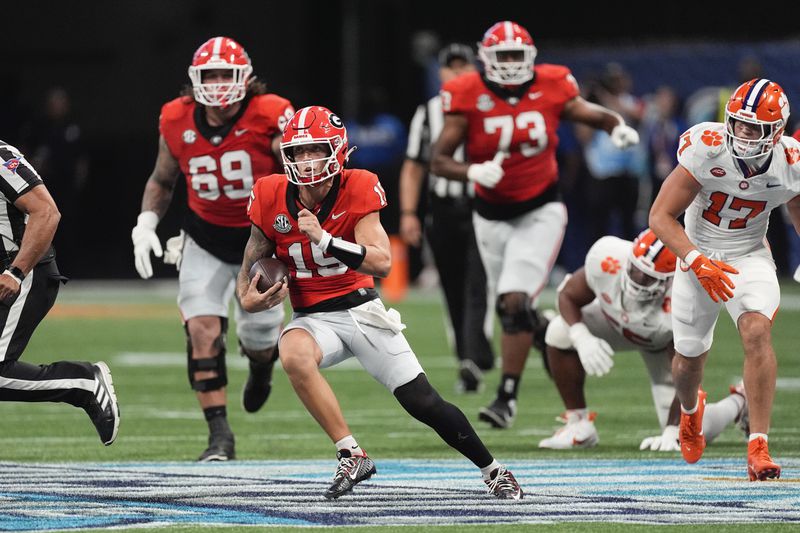 Georgia quarterback Carson Beck (15) looks for running room as Clemson linebacker Wade Woodaz (17) gives chase during the first half of an NCAA college football game Aug. 31, 2024, in Atlanta. (AP Photo/John Bazemore)