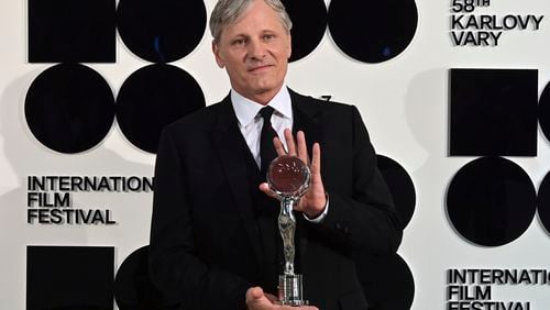 U.S. actor and director Viggo Mortensen poses with the Golden Globe award received during the opening ceremony of the 58th Karlovy Vary International Film Festival in Karlovy Vary, Czech Republic, Friday, June 28, 2024. An international film festival in the western Czech spa of Karlovy Vary has kicked off with an honor for U.S. actor and director Viggo Mortensen. Mortensen, who was nominated three times for the Academy Award as the best actor, received the Festival President’s Award at Friday’s opening ceremony and present the second movie he directed “The Dead Don’t Hurt.” (Slavomir Kubes/CTK via AP)