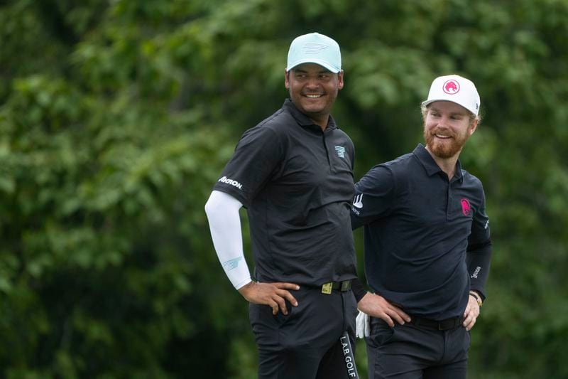 From left to right, Sebastián Muñoz, of Torque GC, and Kieran Vincent, of Legion XIII, smile on the seventh green during the final round of LIV Golf Nashville at The Grove, Sunday, June 23, 2024, in College Grove, Tenn. (Mike Stobe/LIV Golf via AP)
