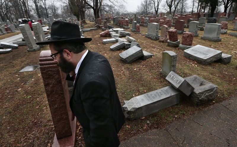 Rabbi Hershey Novack of the Chabad center walks through Chesed Shel Emeth Cemetery in University City, Mo., on Tuesday, Feb. 21, 2017, where almost 200 gravestones were vandalized over the weekend. “People who are Jewish are shocked and angry,” Novack said. (Robert Cohen/St. Louis Post-Dispatch via AP)
