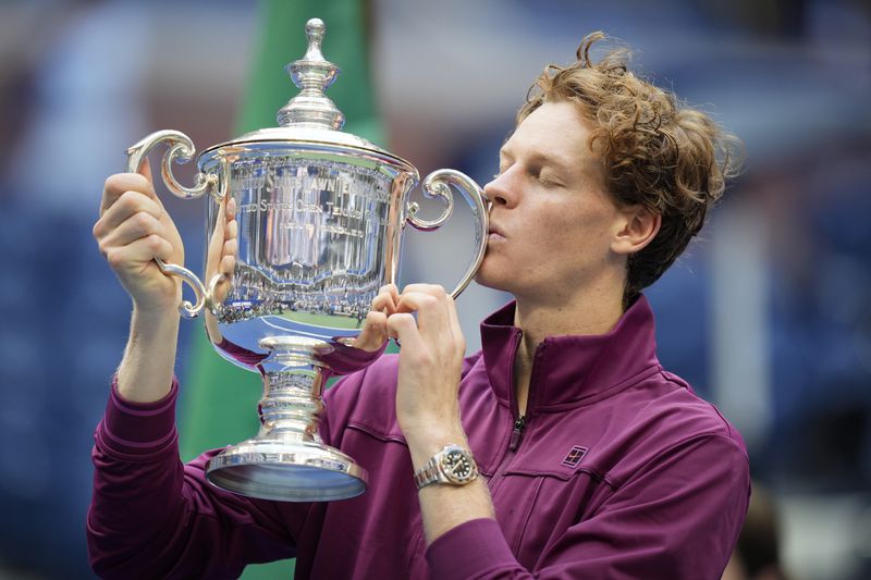 Jannik Sinner, of Italy, kisses the championship trophy after defeating Taylor Fritz, of the United States, in the men's singles final of the U.S. Open tennis championships, Sunday, Sept. 8, 2024, in New York. (AP Photo/Seth Wenig)