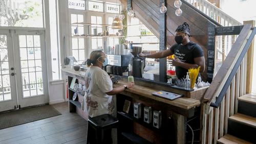 Daniel Brown speaks to customer Angell Foster after preparing her a matcha at Gilly Brew Bar in Stone Mountain on Monday, Aug. 9, 2021. Brown and Nephthaly Leonidas opened the shop that honors their Caribbean heritage with menu items that are influenced by Caribbean food and culture. (Christine Tannous / christine.tannous@ajc.com)