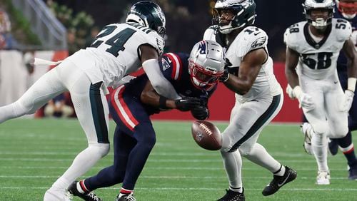 Philadelphia Eagles cornerback James Bradberry IV (24) and linebacker Nakobe Dean (17) break up a pass intended for New England Patriots wide receiver Javon Baker (6) during the first half of an NFL preseason football game, Thursday, Aug. 15, 2024, in Foxborough, Mass. (AP Photo/Mark Stockwell)