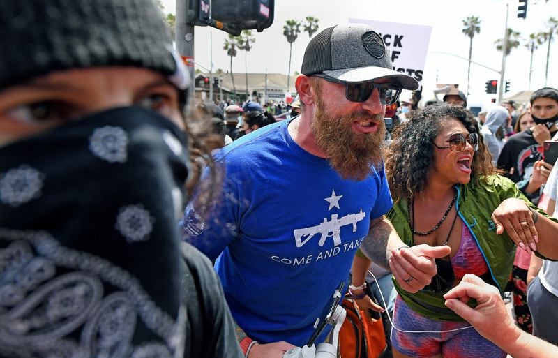 An argument breaks out during Black Lives Matter and White Lives Matter ralliesSunday in Huntington Beach, California.