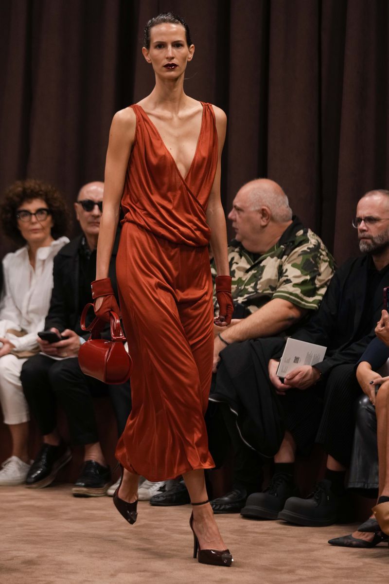 A model wears a creation as part of the Ferrari Spring Summer 2025 collection, that was presented in Milan, Italy, Saturday, Sept. 21, 2024. (AP Photo/Luca Bruno).