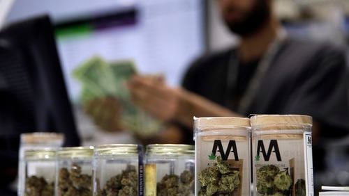 FILE - A cashier rings up a marijuana sale, July 1, 2017, at a cannabis dispensary in Las Vegas. (AP Photo/John Locher, File)