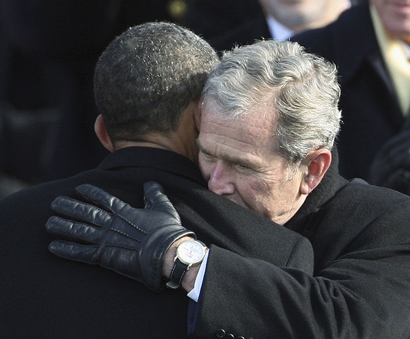 Former President George W. Bush, right, hugs President Barack Obama after Obama was sworn in.