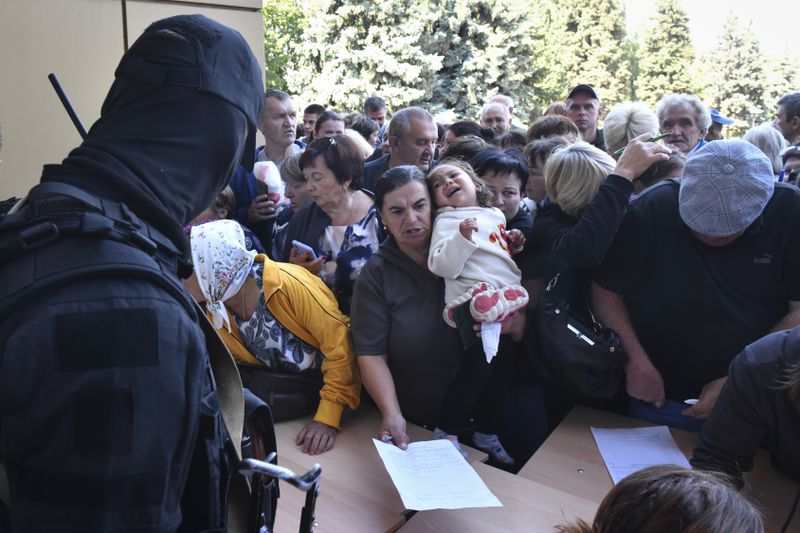 FILE - Evacuees line up to fill out forms at a humanitarian aid distribution center in Kursk, Russia, on Aug. 14, 2024. (AP Photo, File)