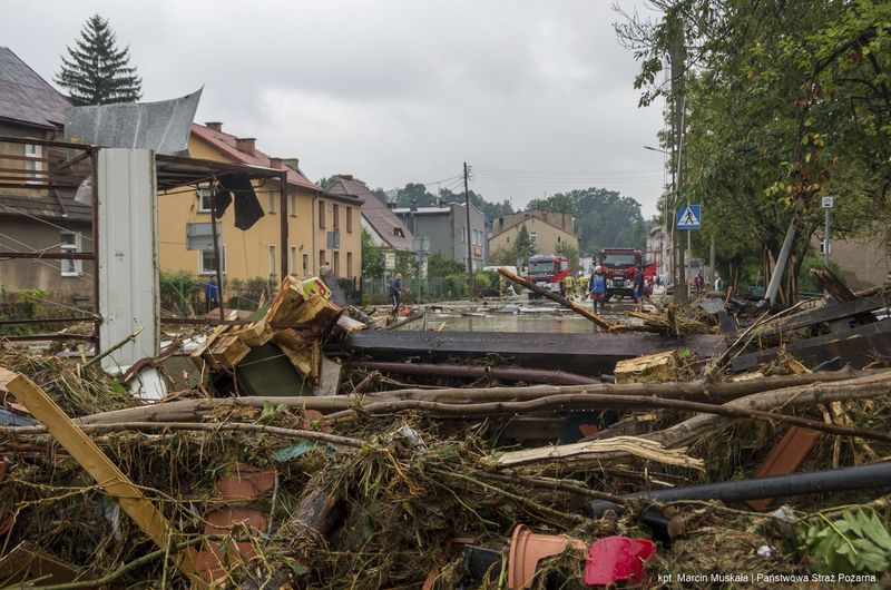 This handout photo provided by the Polish fire department, shows firefighters removing piles of debris dumped in the streets by high flood wave that is passing through southwestern Poland, in Glucholazy, Poland, on Tuesday, Sept. 17, 2024. ( Marcin Muskala/KG PSP via AP)