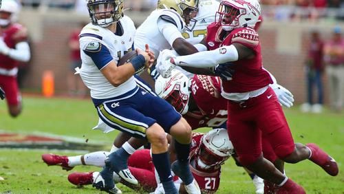 Florida State defensive back Akeem Dent (27) and linebacker Tatum Bethune combine to sack Georgia Tech quarterback Zach Pyron in the first quarter Saturday in Tallahassee, Fla. (AP Photo/Phil Sears)