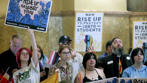 FILE - Kansas high school students, family members and advocates rally for transgender rights, Jan. 31, 2024, at the Statehouse in Topeka, Kan. On Tuesday, July 2, a federal judge in Kansas blocked a federal rule expanding anti-discrimination protections for LGBTQ+ students from being enforced in four states, including Kansas and a patchwork of places elsewhere across the nation. (AP Photo/John Hanna, File)