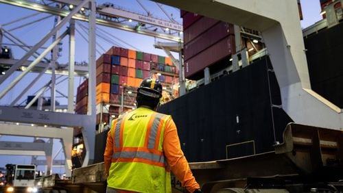 A worker waits for a crane to start moving containers from ship to shore at the Port of Savannah, in Savannah, Ga., Sept. 30, 2021. (Erin Schaff/The New York Times)