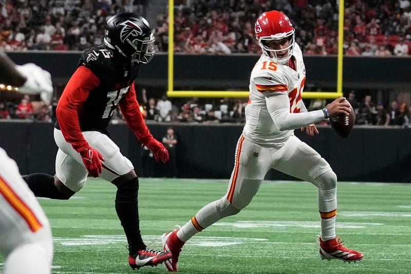 Kansas City Chiefs quarterback Patrick Mahomes (15) runs out of the pocket as Atlanta Falcons linebacker Matthew Judon (15) defends during the second half of an NFL football game, Sunday, Sept. 22, 2024, in Atlanta. (AP Photo/Brynn Anderson)