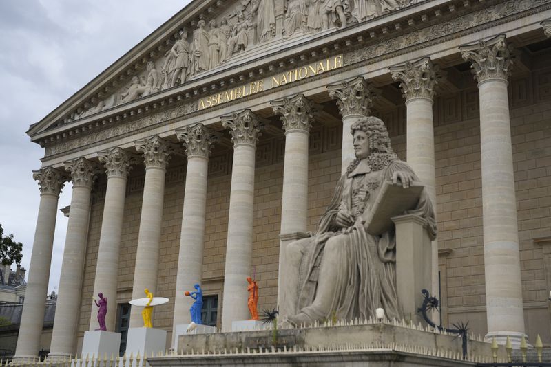 Copies of one of the most famous Greek statues, the Venus of Milo, now equipped with the attributes of six sporting disciplines, are installed on the steps of the French National Assembly Wednesday, July 3, 2024 in Paris. French President Emmanuel Macron dissolved the National Assembly and called the snap election on June 9 after a stinging defeat at the hands of the National Rally in French voting for the European Parliament. The second round of the legislative will take place Sunday July 7. (AP Photo/Thibault Camus)