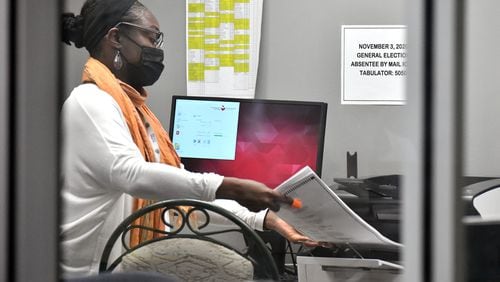 November 4, 2020 Decatur - Workers scan and tabulate absentee ballots at DeKalb Voter Registration & Elections building in Decatur on Wednesday, November 4, 2020. (Hyosub Shin / Hyosub.Shin@ajc.com)