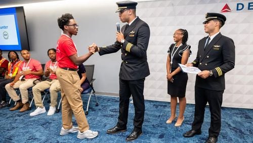 Delta Air Lines Pilot Justin Mutawassim shakes hands with a student during an ACE and Solo Flight Academy event. (Photo Courtesy of Delta Air Lines)